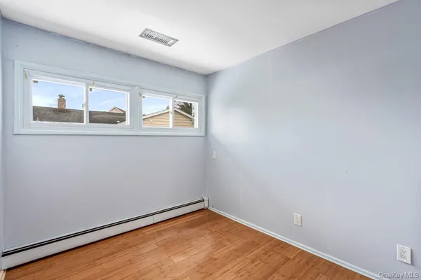 a bathroom with a granite countertop sink a large mirror and a bathtub