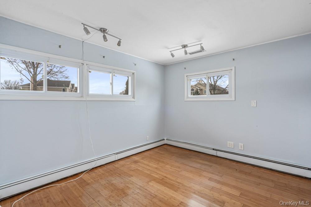 1 Virginia Road Syosset, NY 11791 - Photo 7 of 16 a view of room with window and wooden floor