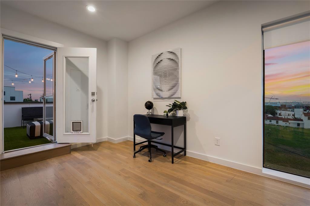 1002 Mobile Street, Unit 1 Dallas, TX 75208 - Photo 22 of 34 a view of a workspace room with wooden floor and bathroom