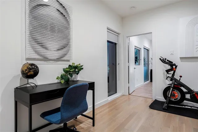 a view of a workspace with furniture and wooden floor