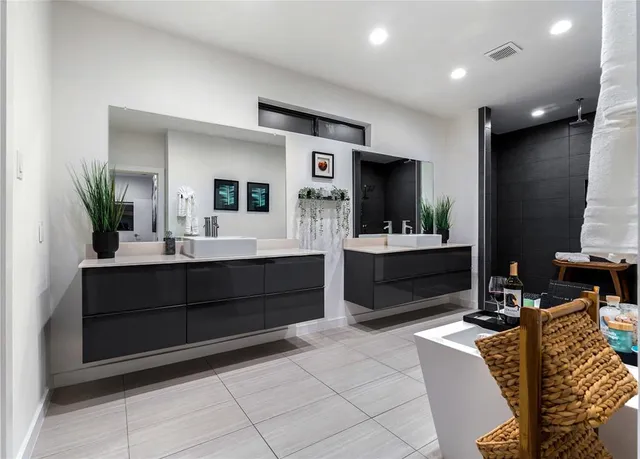 a bathroom with a sink double vanity and a mirror
