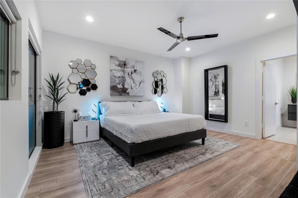 1002 Mobile Street, Unit 1 Dallas, TX 75208 - Photo 27 of 34 a spacious bedroom with a bed and a table