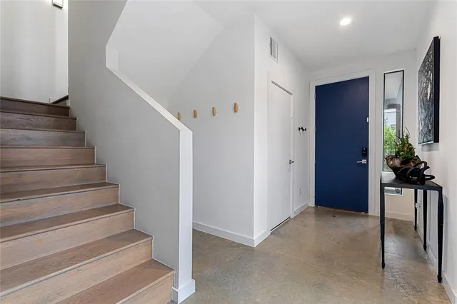 a view of entryway with wooden floor and stairs