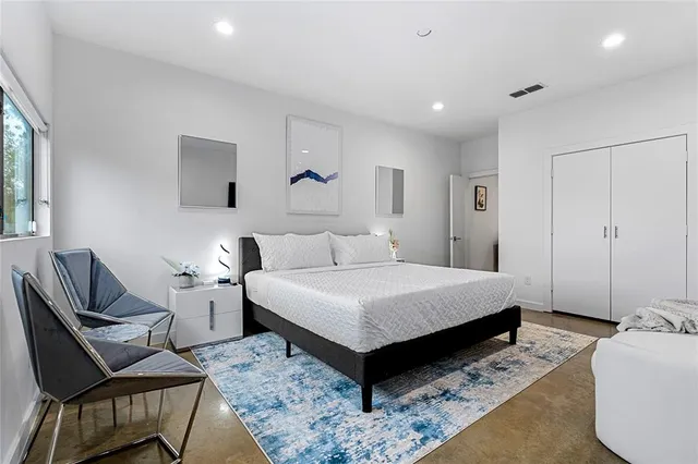 a bedroom with a bed and a couch