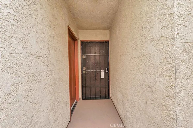 a view of a hallway with wooden shelves