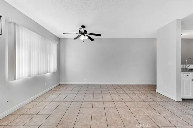 a view of an empty room with window and cabinet