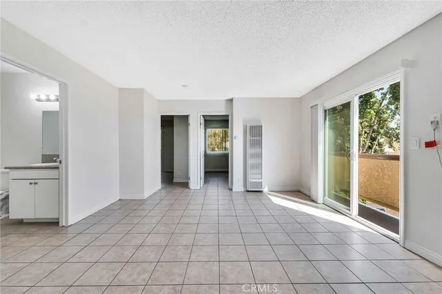 a kitchen with granite countertop white cabinets and appliances