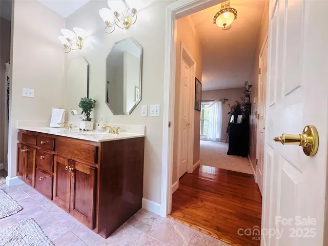 a spacious bathroom with a tub and mirror