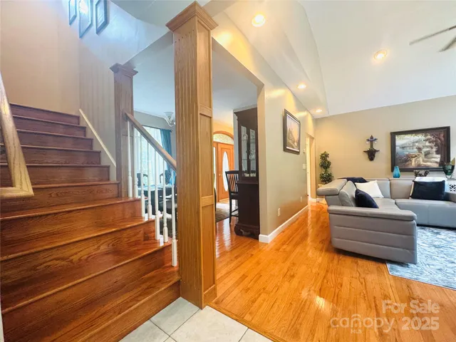 a view of entryway and hall with wooden floor