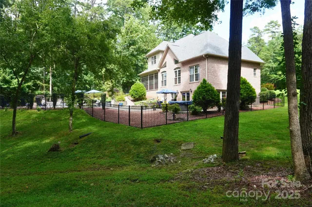 a view of a house with a yard deck and a garden