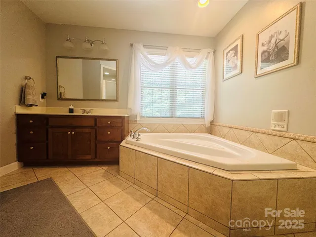 a spacious bedroom with a bed and a window