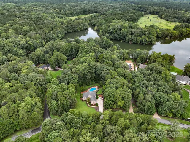 a view of patio with a table and chairs under an umbrella