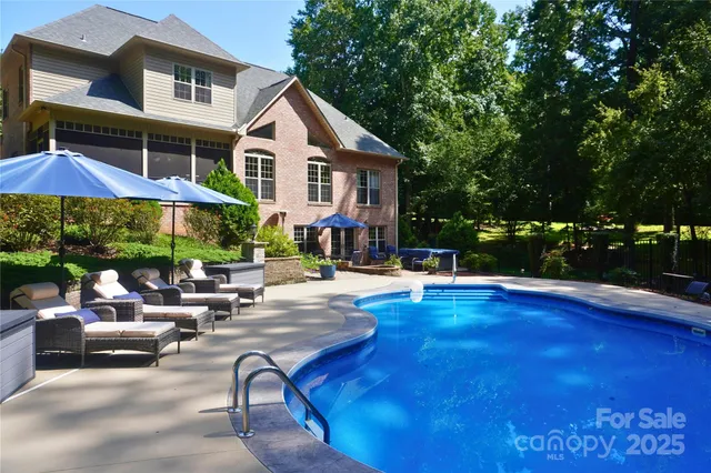 a view of a patio with chairs and plants