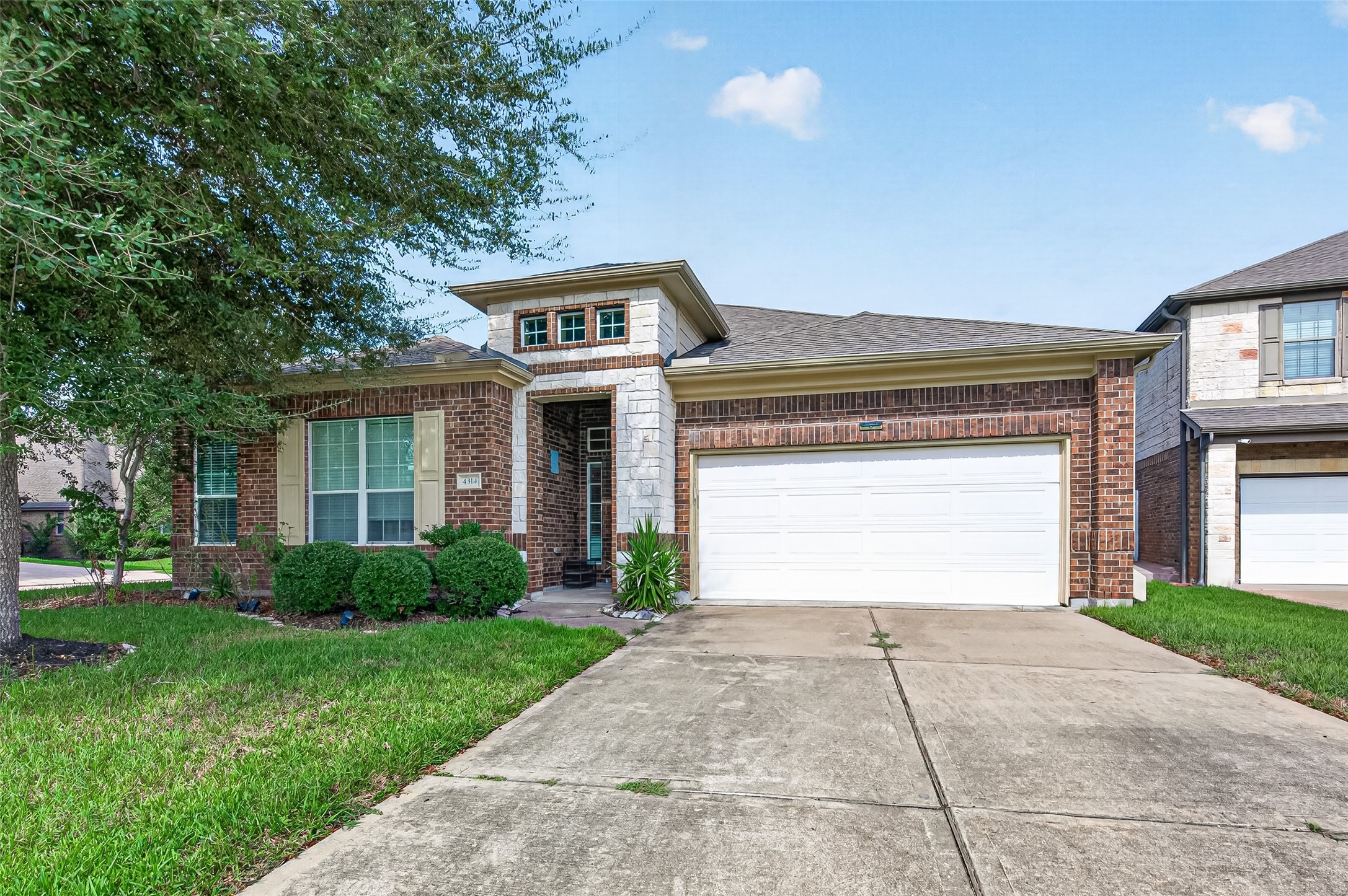 4314 Kent Ranch Court Katy, TX 77494 - Photo 49 of 49 Brick and stone front exterior with an extended driveway, two-car garage and landscaped beds.