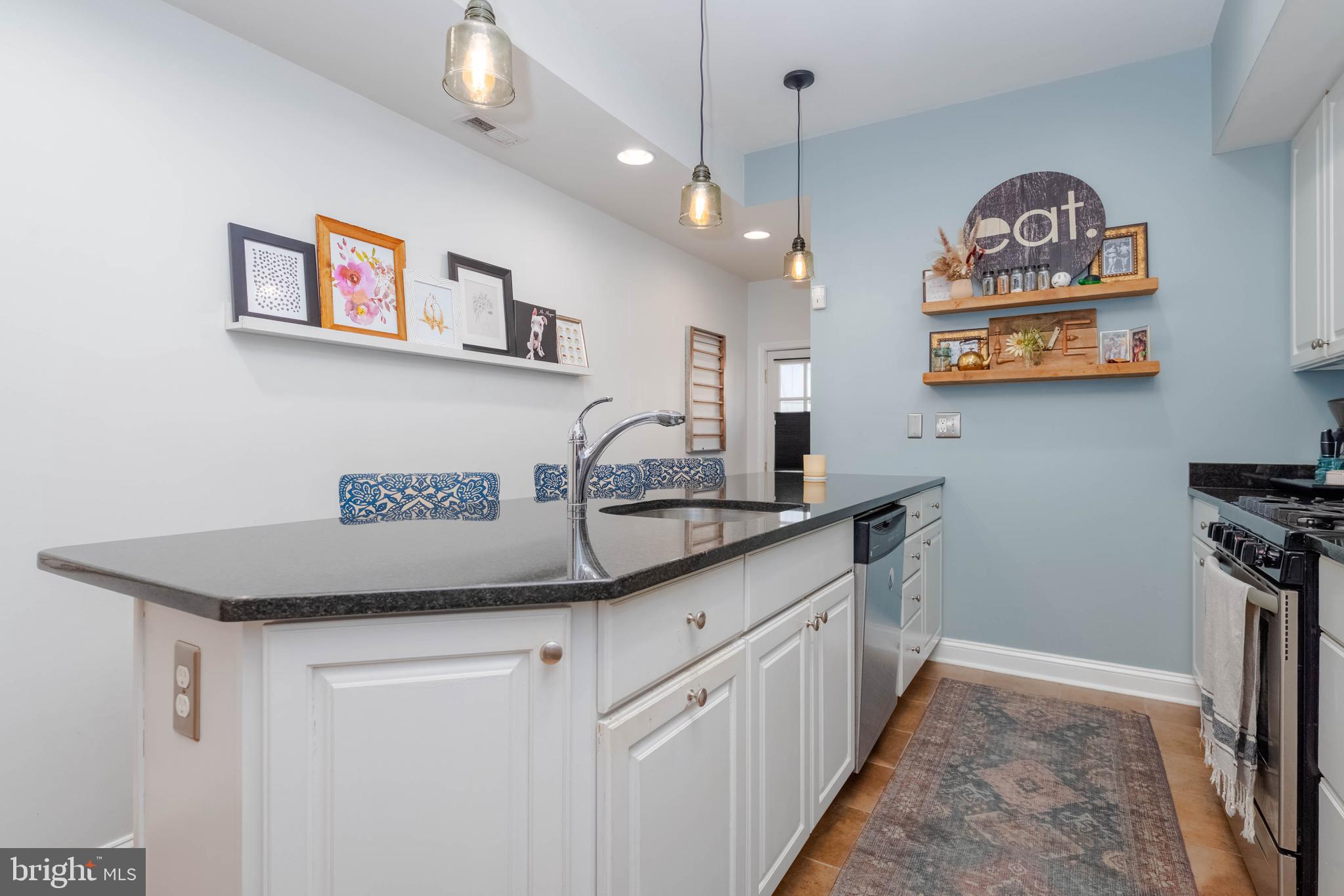 318 South Duncan Street Baltimore, MD 21231 - Photo 11 of 27 a kitchen with stainless steel appliances granite countertop a sink and a refrigerator