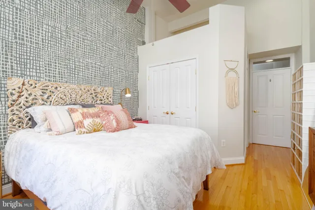 a bedroom with a bed and wooden floor