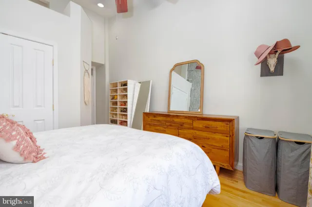 a bedroom with a bed and wooden floor