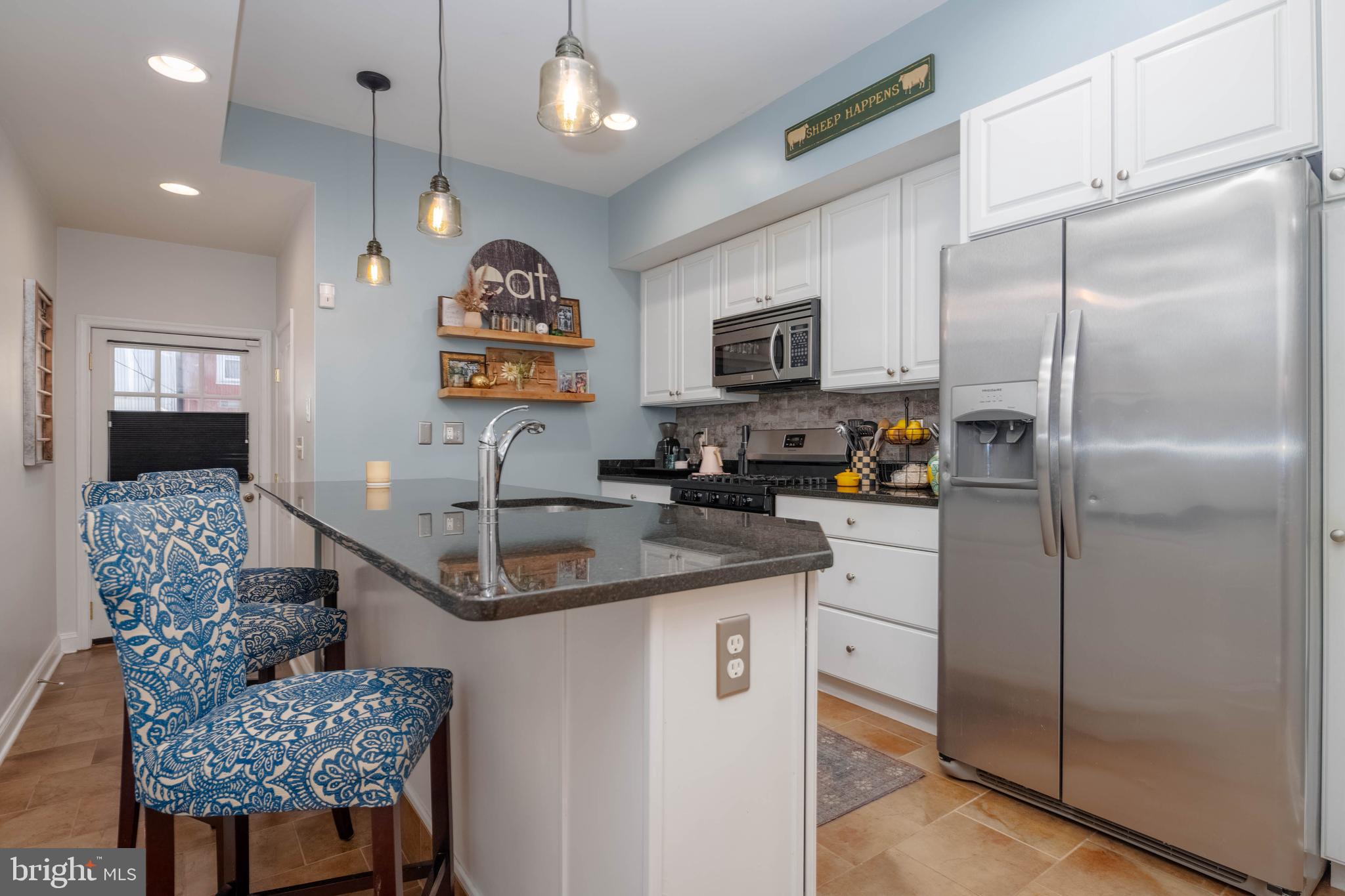 318 South Duncan Street Baltimore, MD 21231 - Photo 8 of 27 a kitchen with stainless steel appliances granite countertop a sink refrigerator and microwave