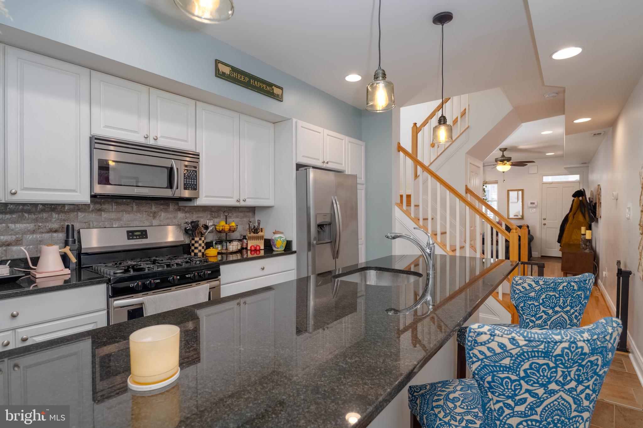318 South Duncan Street Baltimore, MD 21231 - Photo 10 of 27 a kitchen with granite countertop a stove a sink and a refrigerator