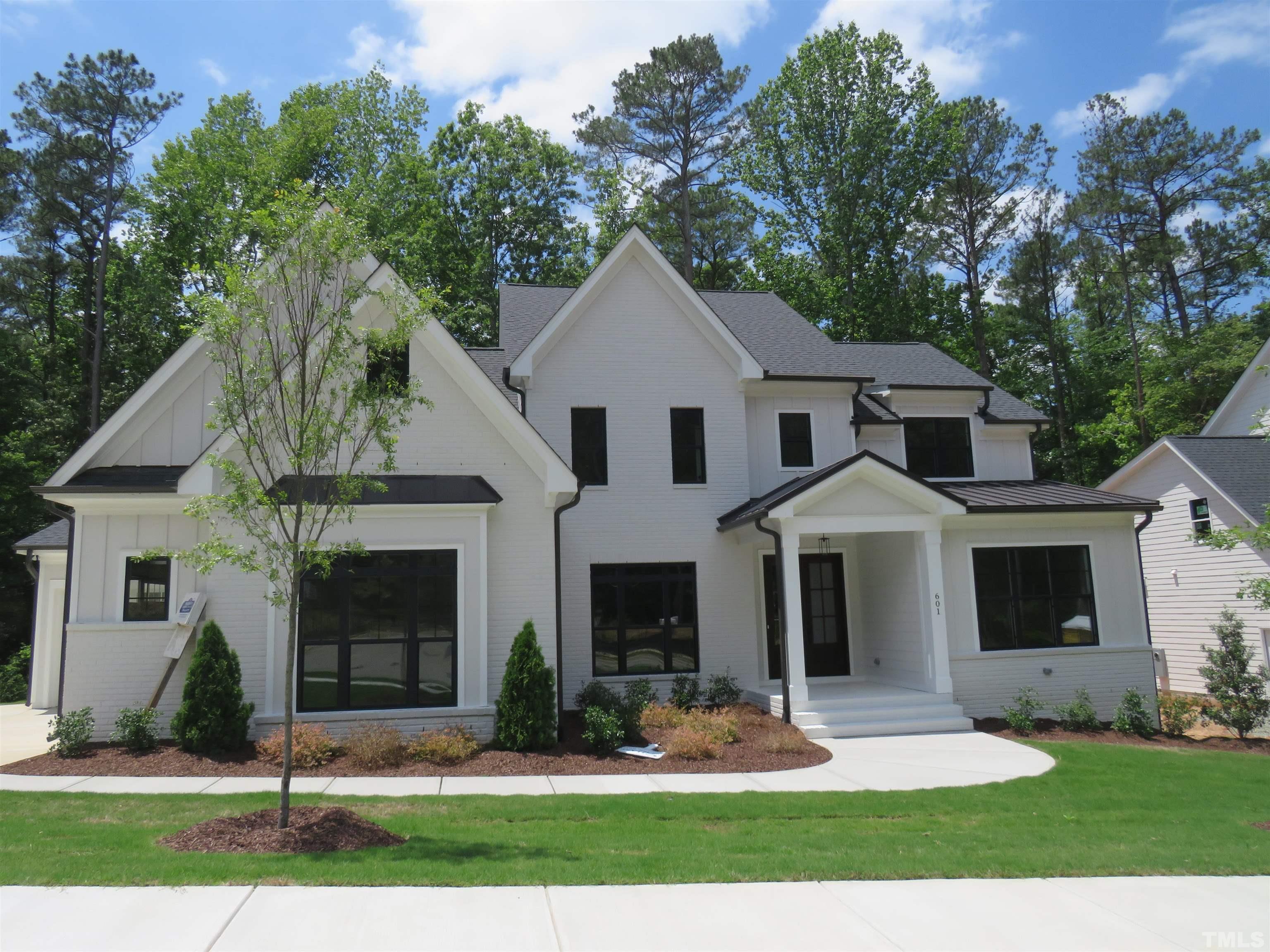 601 Ansley Ridge Place Cary, NC 27518 - Photo 2 of 2 a front view of a house with a yard and garage