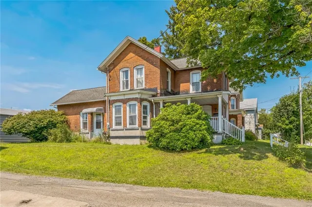 a front view of a house with garden