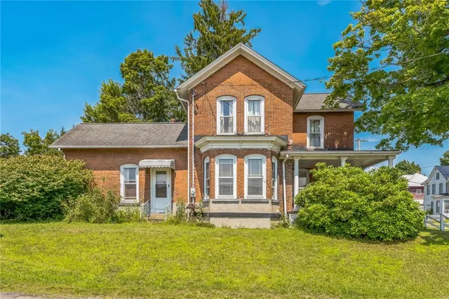 a front view of a house with a yard