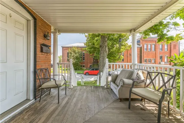 a view of a chairs and table in the balcony