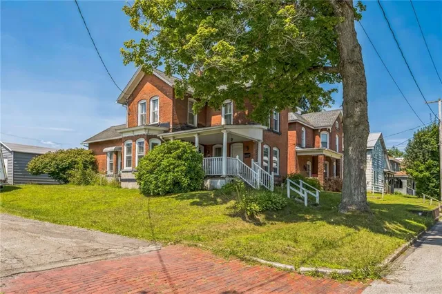 a front view of a house with a yard