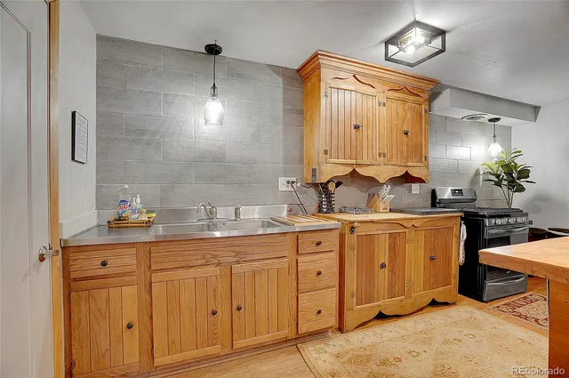 a kitchen with stainless steel appliances granite countertop lots of counter top space and wooden floor