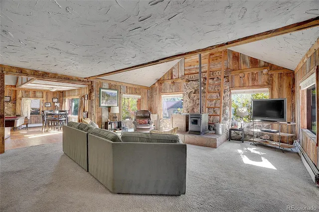 a living room with furniture and a floor to ceiling window