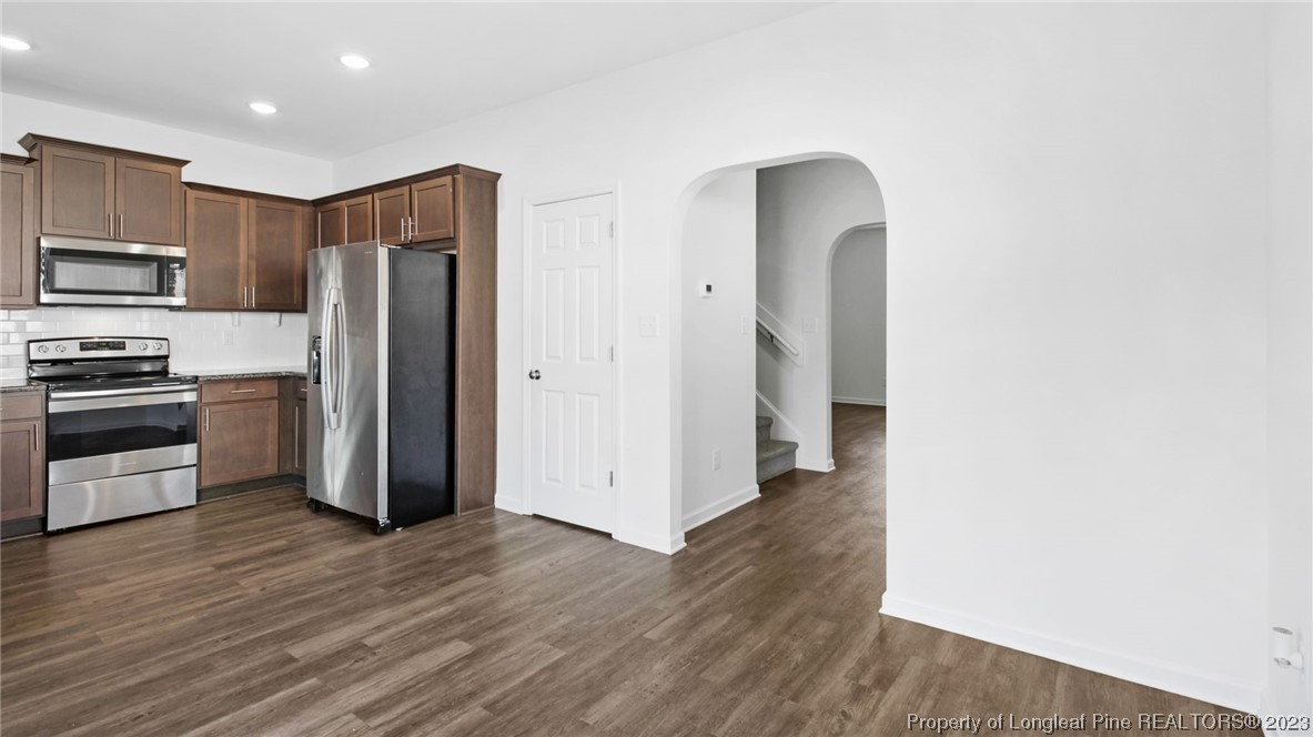 217 Fieldbrook Street Raeford, NC 28376 - Photo 11 of 42 a view of a kitchen with wooden floor and electronic appliances