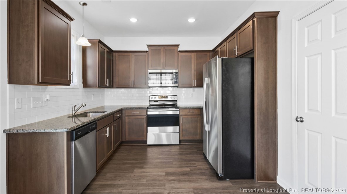 217 Fieldbrook Street Raeford, NC 28376 - Photo 12 of 42 a kitchen with stainless steel appliances granite countertop a refrigerator a stove top oven a sink and dishwasher