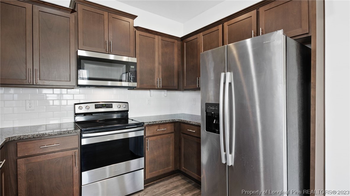 217 Fieldbrook Street Raeford, NC 28376 - Photo 14 of 42 a kitchen with cabinets and steel stainless steel appliances