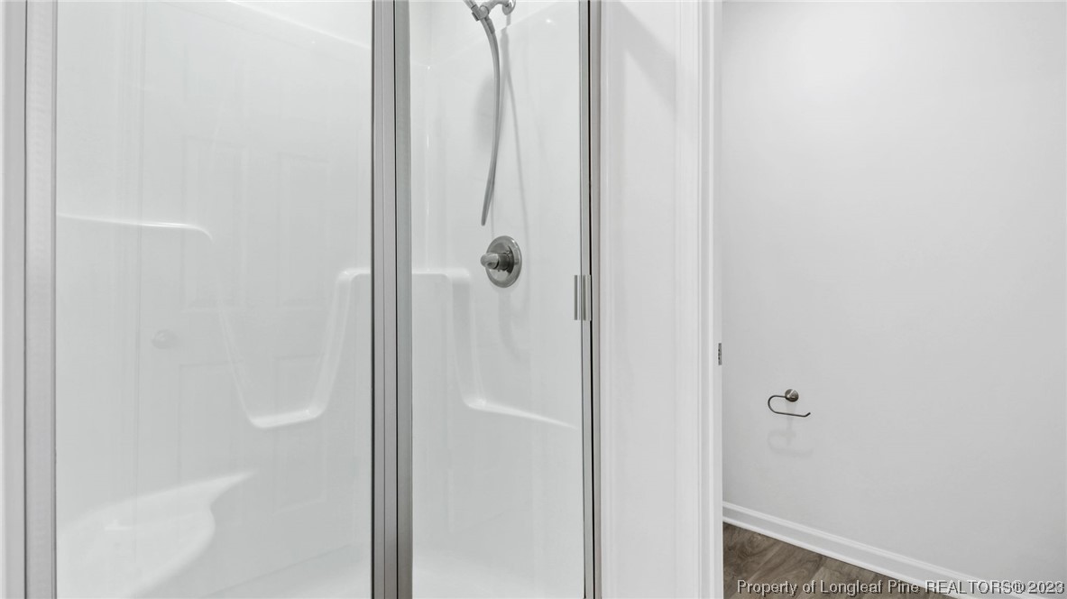 217 Fieldbrook Street Raeford, NC 28376 - Photo 20 of 42 a bathroom with a glass shower door