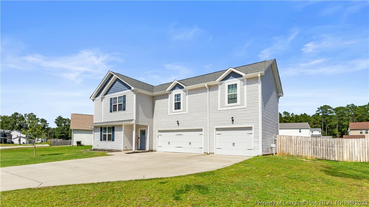217 Fieldbrook Street Raeford, NC 28376 - Photo 3 of 42 a view of an house with backyard porch and garden