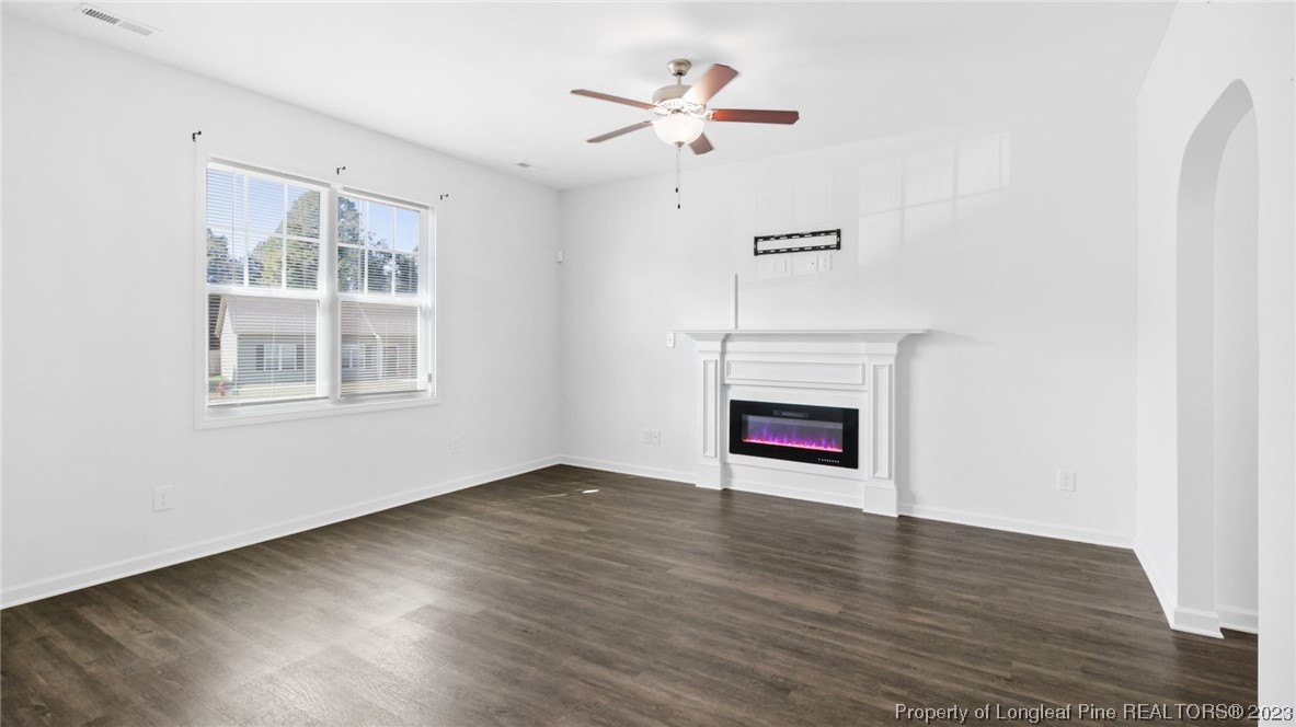 217 Fieldbrook Street Raeford, NC 28376 - Photo 4 of 42 a view of an empty room with a window and wooden floor