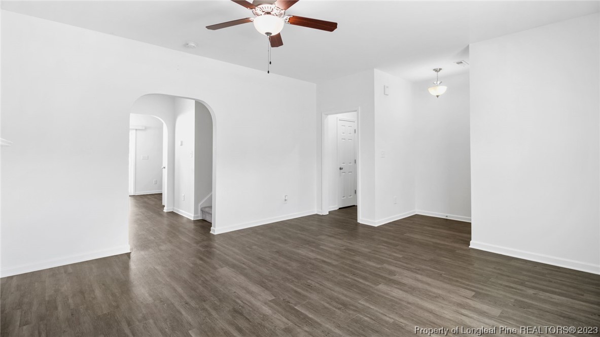 217 Fieldbrook Street Raeford, NC 28376 - Photo 6 of 42 an empty room with wooden floor and a ceiling fan