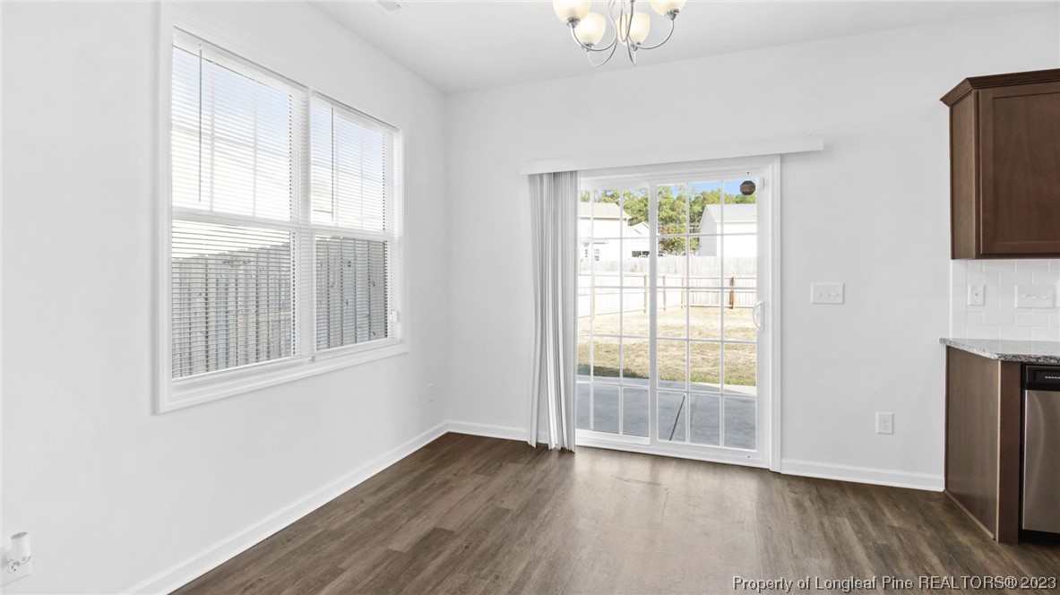 217 Fieldbrook Street Raeford, NC 28376 - Photo 10 of 42 an empty room with wooden floor and windows