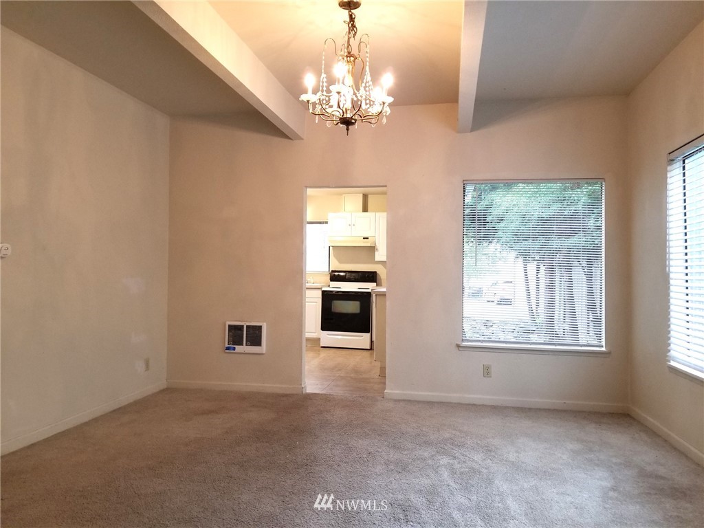 2321 Rucker Avenue Everett, WA 98201 - Photo 5 of 12 en empty room with windows and chandelier