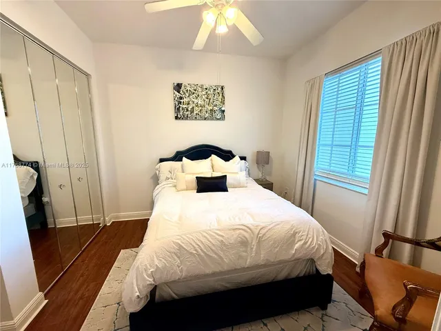 a bedroom with a bed and a mirror