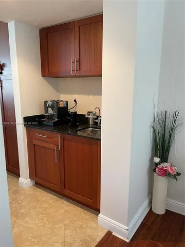 a room with a sink and cabinets