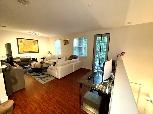 a living room with furniture window and a flat screen tv