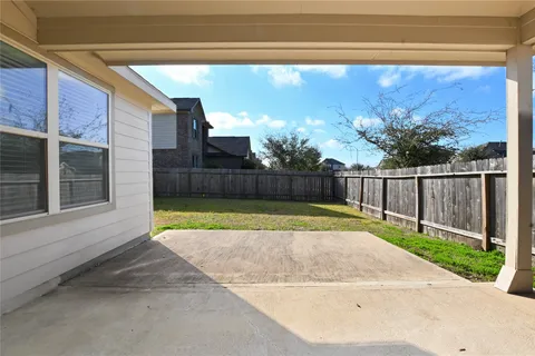 a view of backyard with swimming pool and outdoor seating