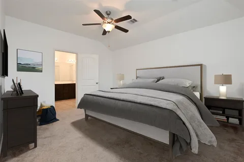 a bedroom with a bed couch and window