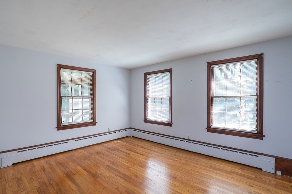 152 Feeding Hills Road Southwick, MA 01077 - Photo 15 of 35 an empty room with wooden floor and windows