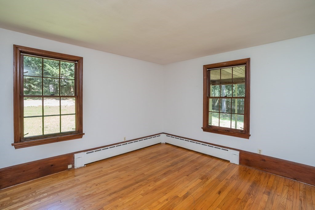 152 Feeding Hills Road Southwick, MA 01077 - Photo 16 of 35 a view of an empty room with wooden floor and a window