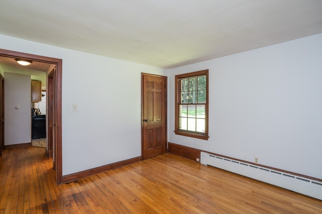 152 Feeding Hills Road Southwick, MA 01077 - Photo 17 of 35 an empty room with wooden floor and windows