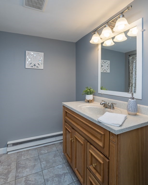 152 Feeding Hills Road Southwick, MA 01077 - Photo 18 of 35 a bathroom with a sink a vanity and a mirror