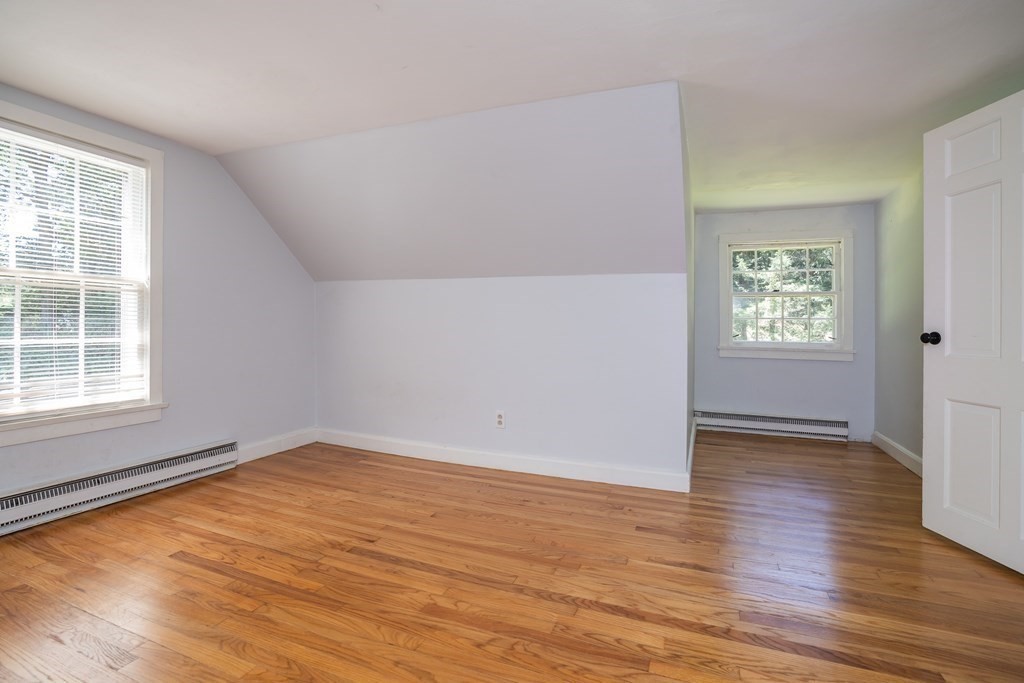 152 Feeding Hills Road Southwick, MA 01077 - Photo 21 of 35 an empty room with wooden floor and windows
