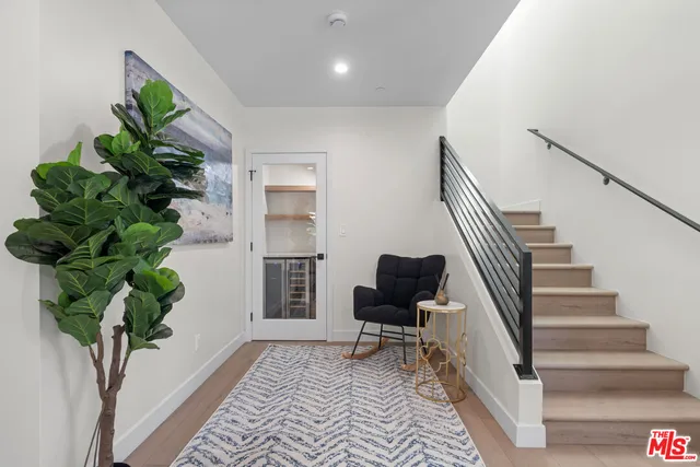 a spacious bedroom with a bed and a chandelier